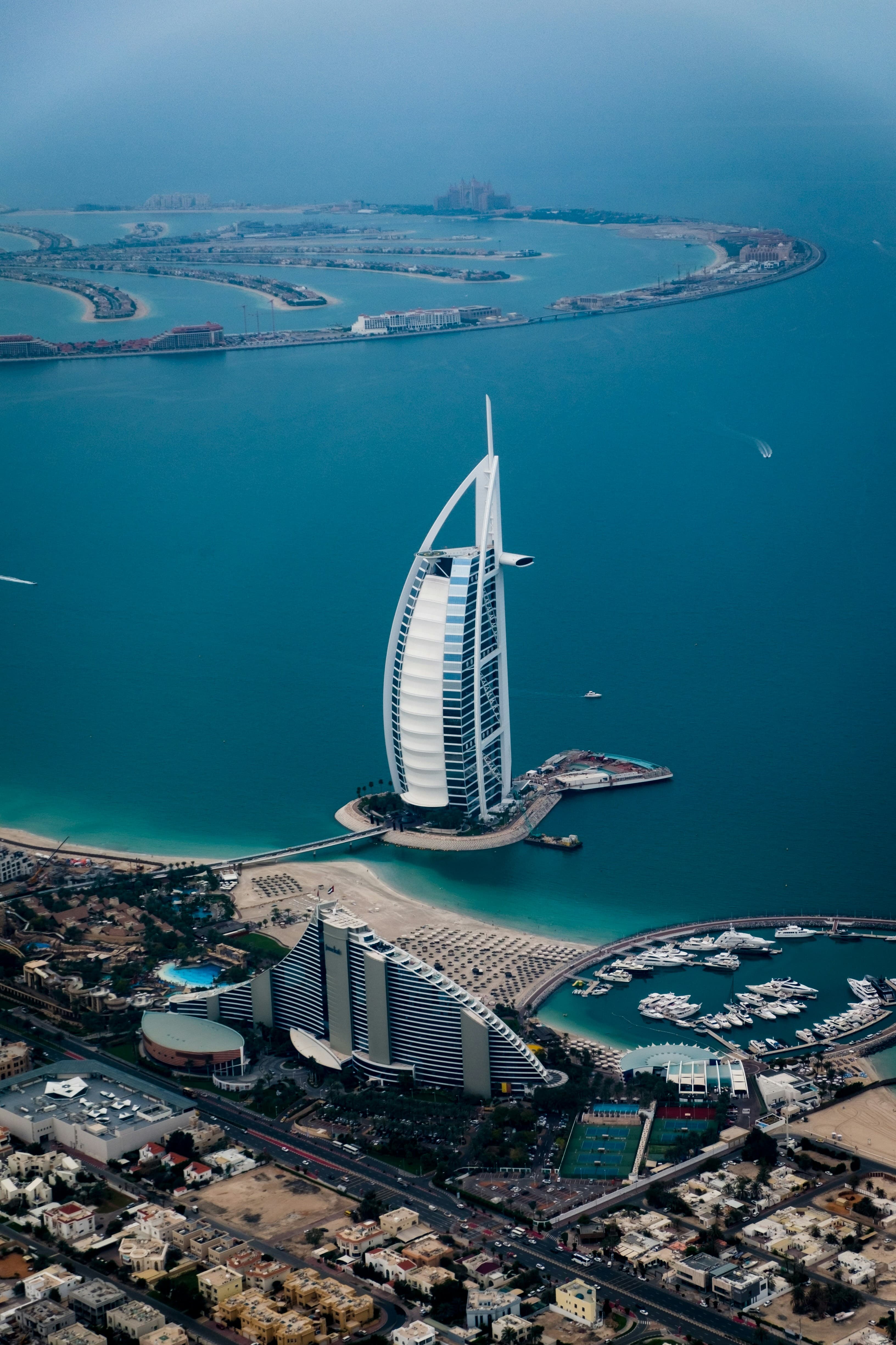 Aerial view of the Burj Al Arab and Dubai coastline with Palm Jumeirah in the distance